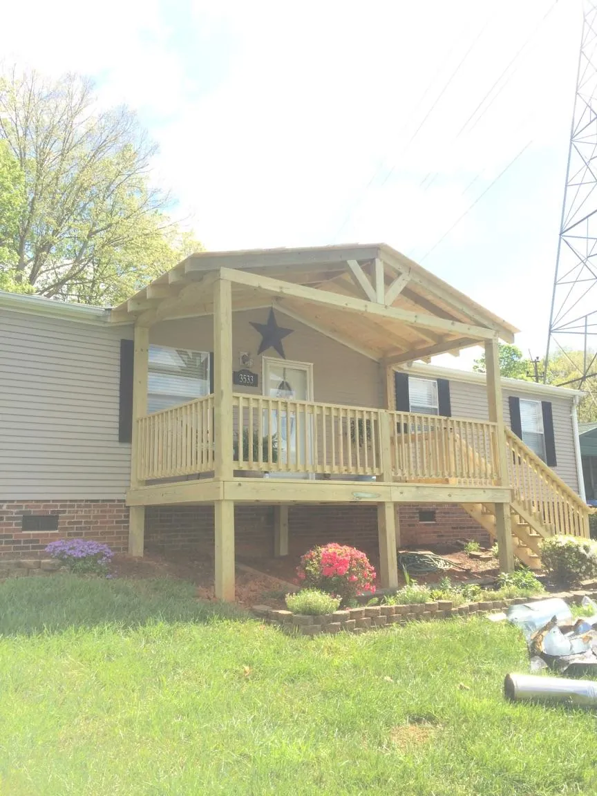 New gabled porch roof and deck railing added to a ranch home in Seaford